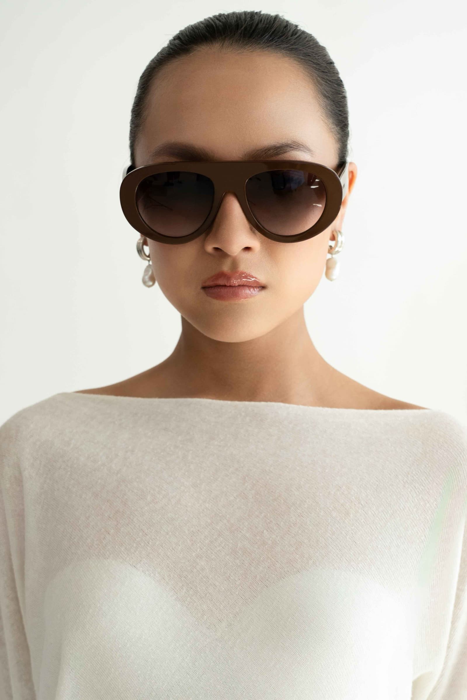 The Muse Brown sunglasses worn, front view