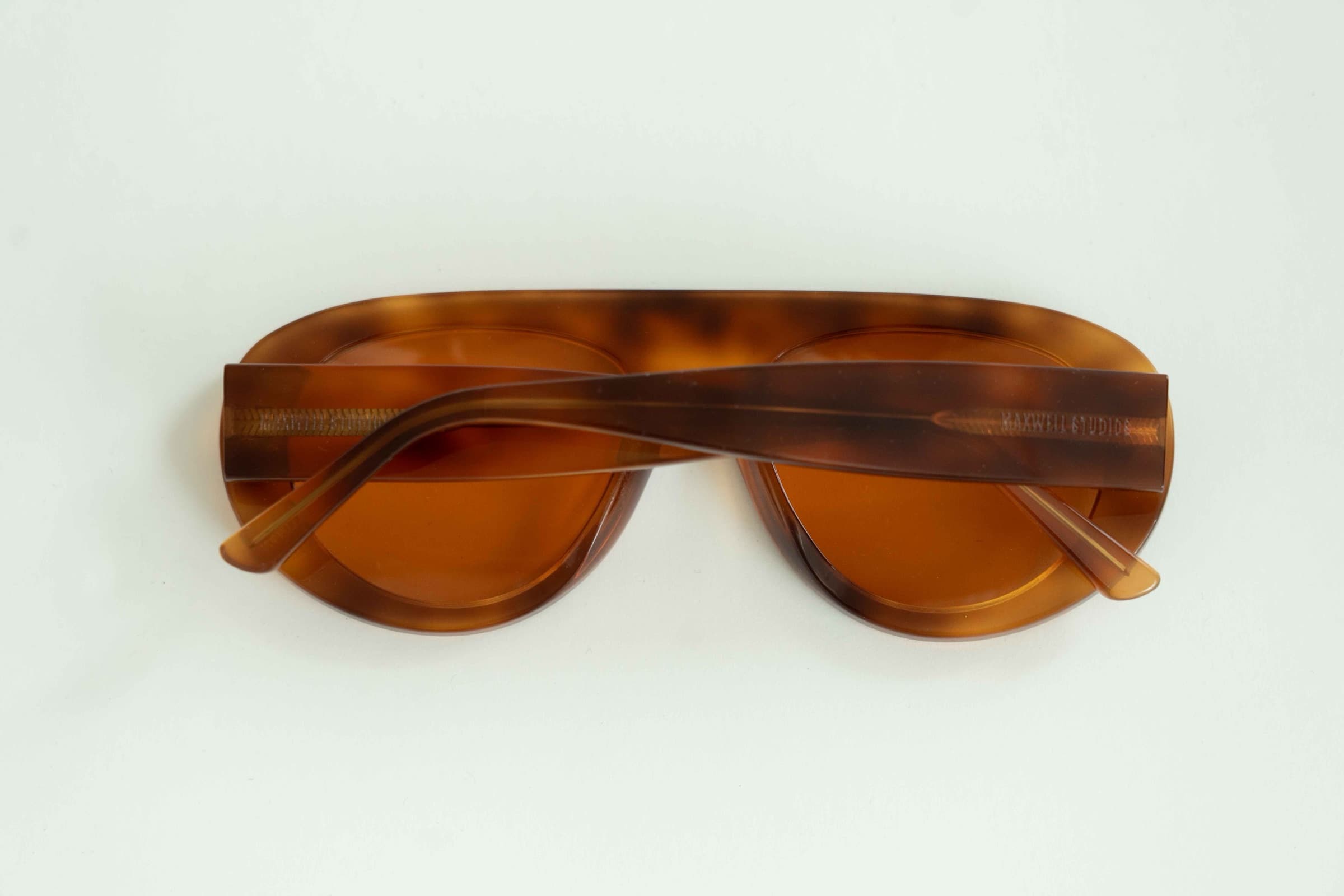 The Muse Orange Tortoise sunglasses, back view on a clean background